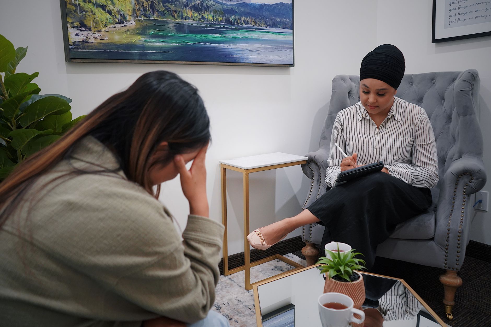 Psychiatrist reviewing patient intake documentation, illustrating the difference in 90791 vs 90792 billing eligibility by provider type