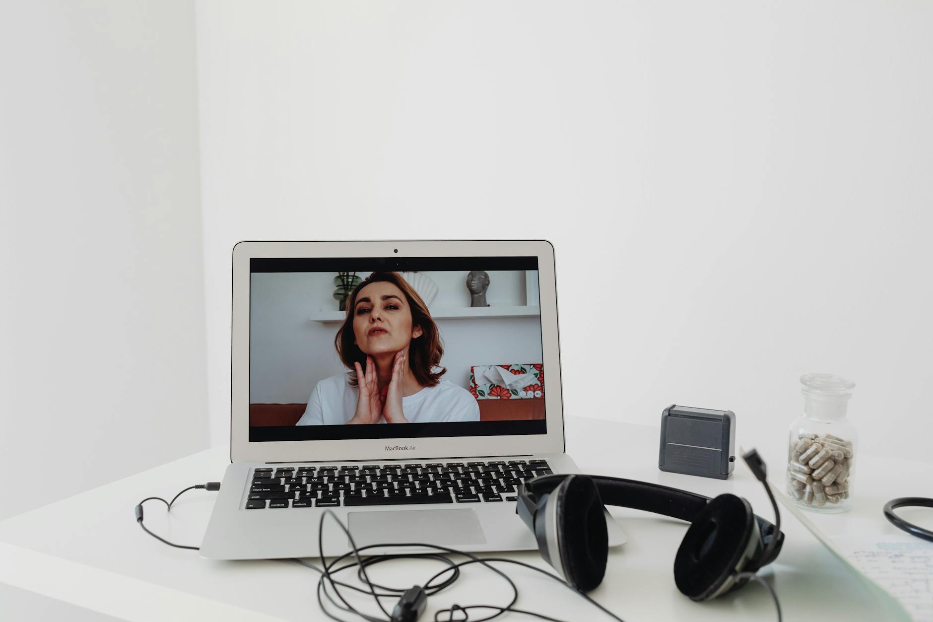 Mental health telehealth billing setup showing a therapist conducting a live video session, illustrating POS 10 and modifier 95 coding requi