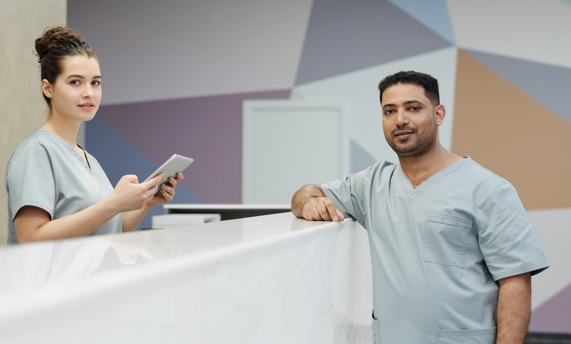 Front-desk staff reviewing patient billing and collections workflow on a practice management screen to improve upfront payment rates